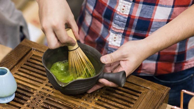 Person mixing matcha tea