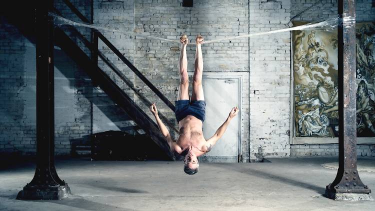 High Performance Packing Tape man upside down on packing tape bridge