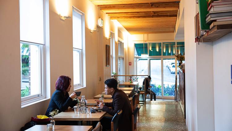 People sitting inside cafe at One Another Cafe Newtown