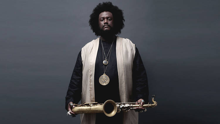 Kamasi Washington press shot holding saxophone