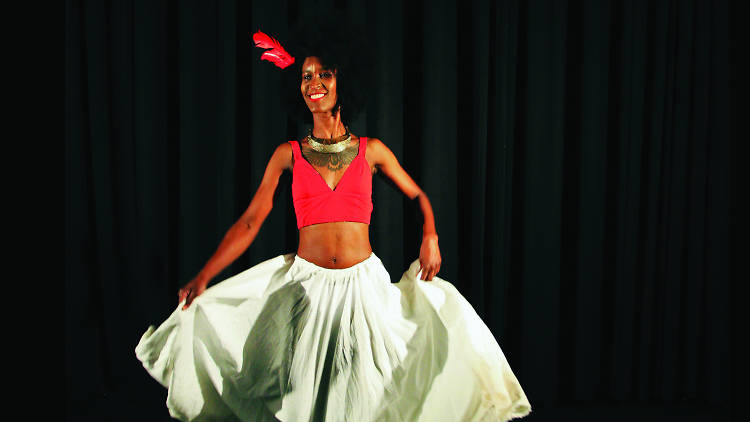 Woman in red top and white skirt dancing