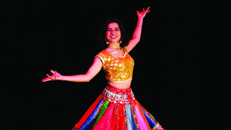 Woman in colourful Bollywood costume posing