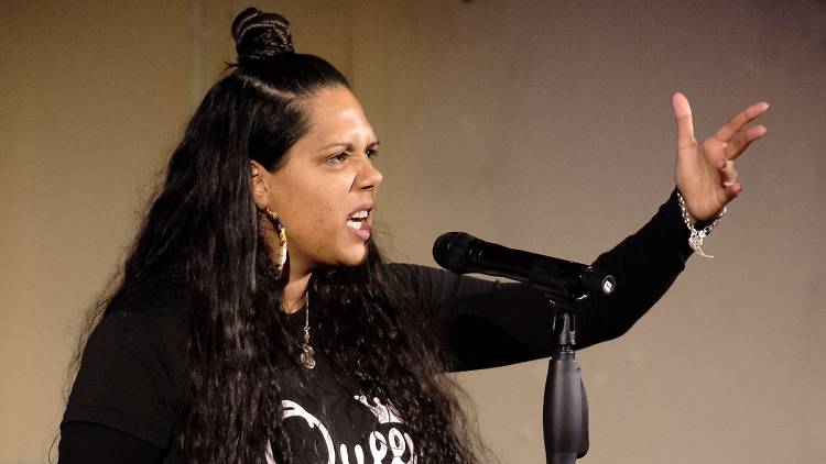 Poet and writer Melanie Mununggurr-Williams speaks into a microphone.