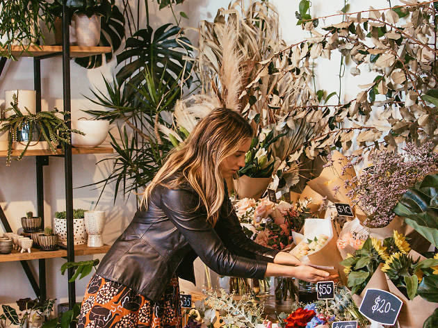 Wild Forager florist in Freshwater Woman looking at flowers in Wild Forager store Sydney