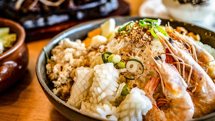 Bowl of seafood fried rice and other dishes at Kasalo