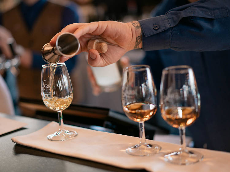 Person pouring drams of whisky