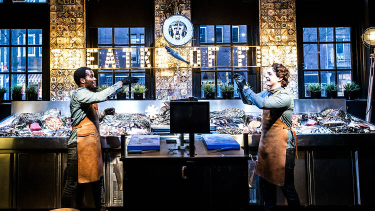 Staff throw a fish at Pesca restaurant in Amsterdam