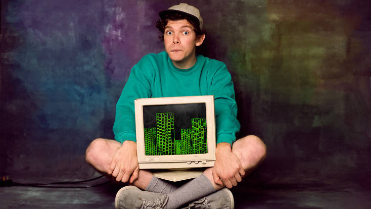 Actor from theatre show Tröll sits with a computer screen