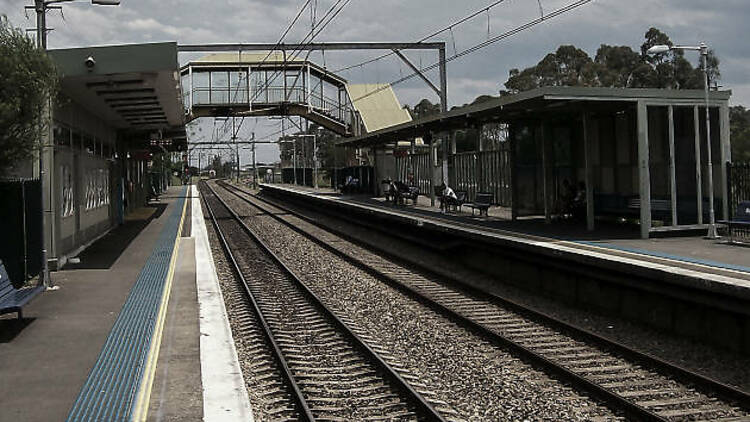 The tracks at daytime at Macquarie Fields Train Station.