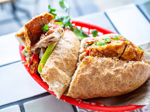 Banh mi at Great Aunty Three Enmore Banh mi cut in half with pork crackling in a red basket