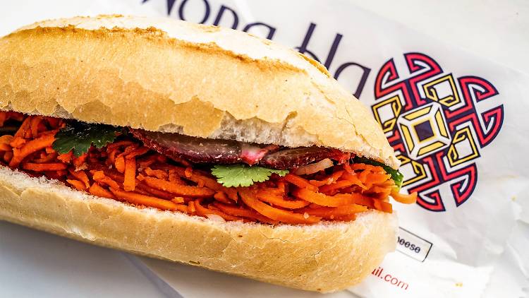 A pork banh mi resting on a bag at Hong Ha bakery