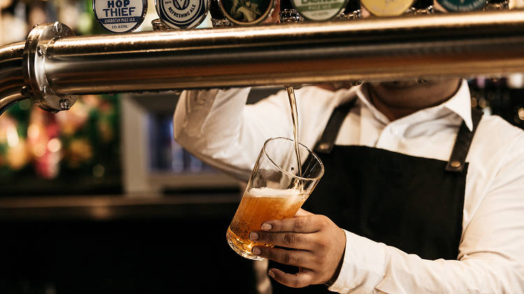 Person pouring a beer