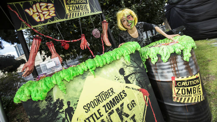 Woman wearing creepy face paint at a Halloween-themed stall