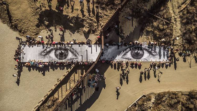 JR, Migrants, Mayra, Picnic across the border, Tecate, Mexico–U.S.A., 2017