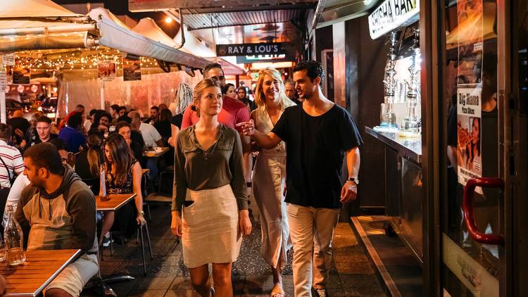 People dining at restaurants along Eat Street dining precinct in