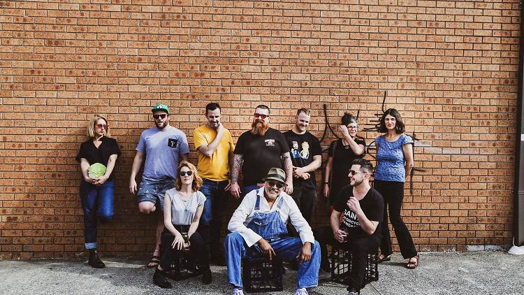 People standing in front of a brick wall.