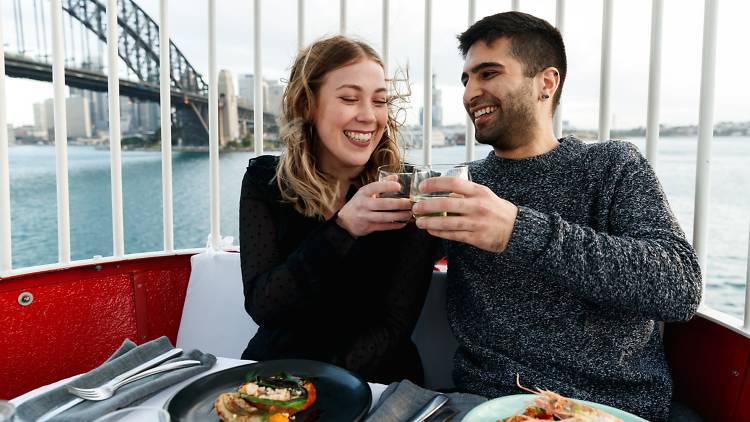 A couple smiles while they ride the Luna Park Ferris Wheel 