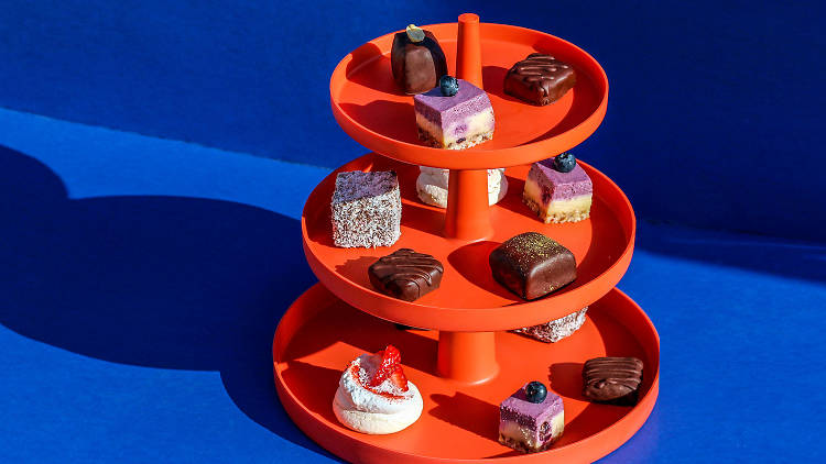 The vegan, gluten-free snacks at Higher Tea on a red tiered platform. 