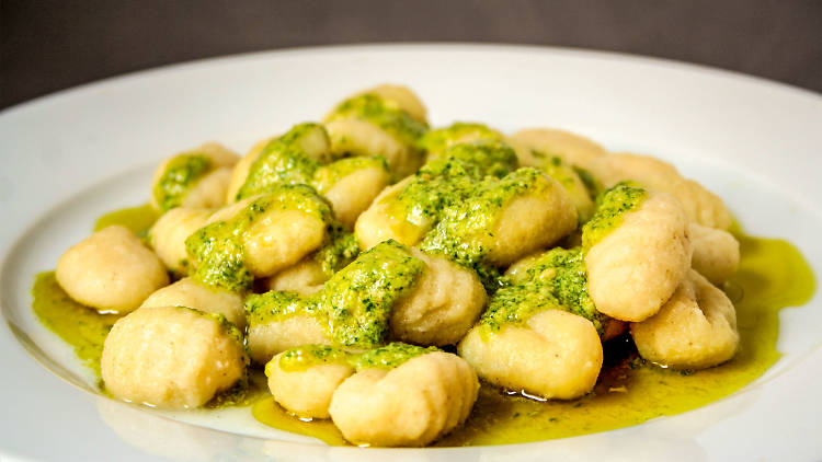 A plate of gnocchi with pesto