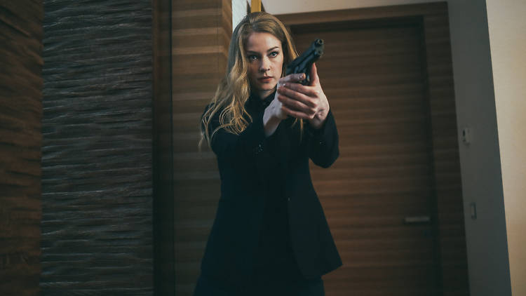 Movie still of a woman holding a gun from Russian movie Hero.