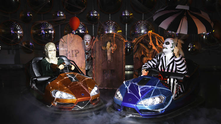 Beetlejuice and random man in costume driving dodgem cars