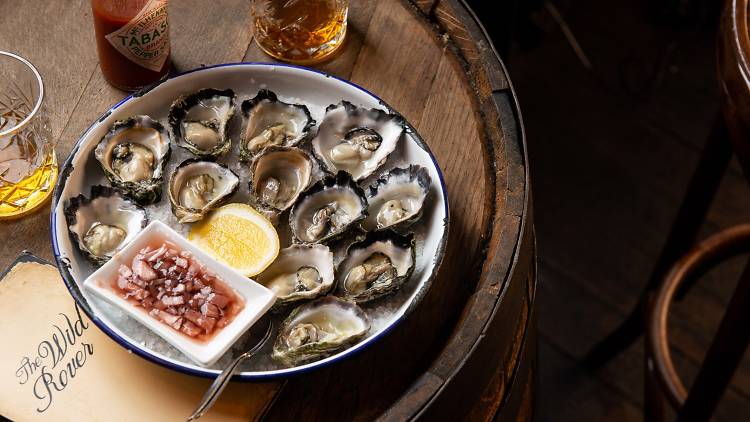A plate of Sydney rock oysters and whisky at Wild Rover Oyster Fest