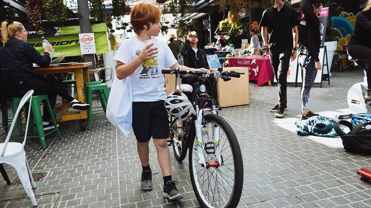 Young child wheeling his bike through Barkly Bikes Festival