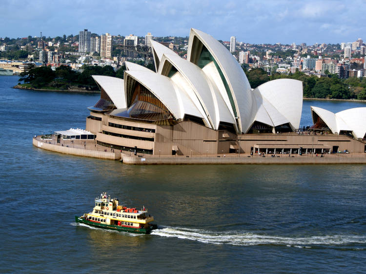 Boat in Sydney Harbour next to Sydney Opera House 