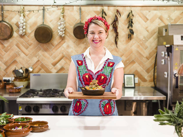 Hearth & Soul Rachel Jelley standing in an open kitchen holding a plate