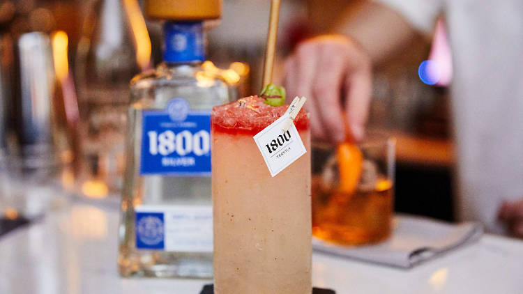 1800 Tequila cocktail on a bar.