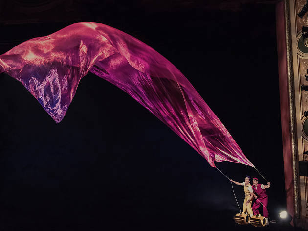 Air Play Characters in children's theatre show Air Play hold a long purple scarf in the wind.