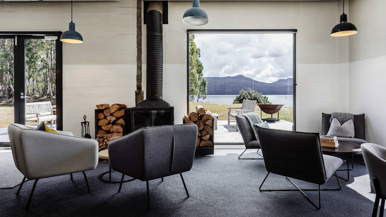 Armchairs and a woodfire in one of Pumphouse Point's lounges