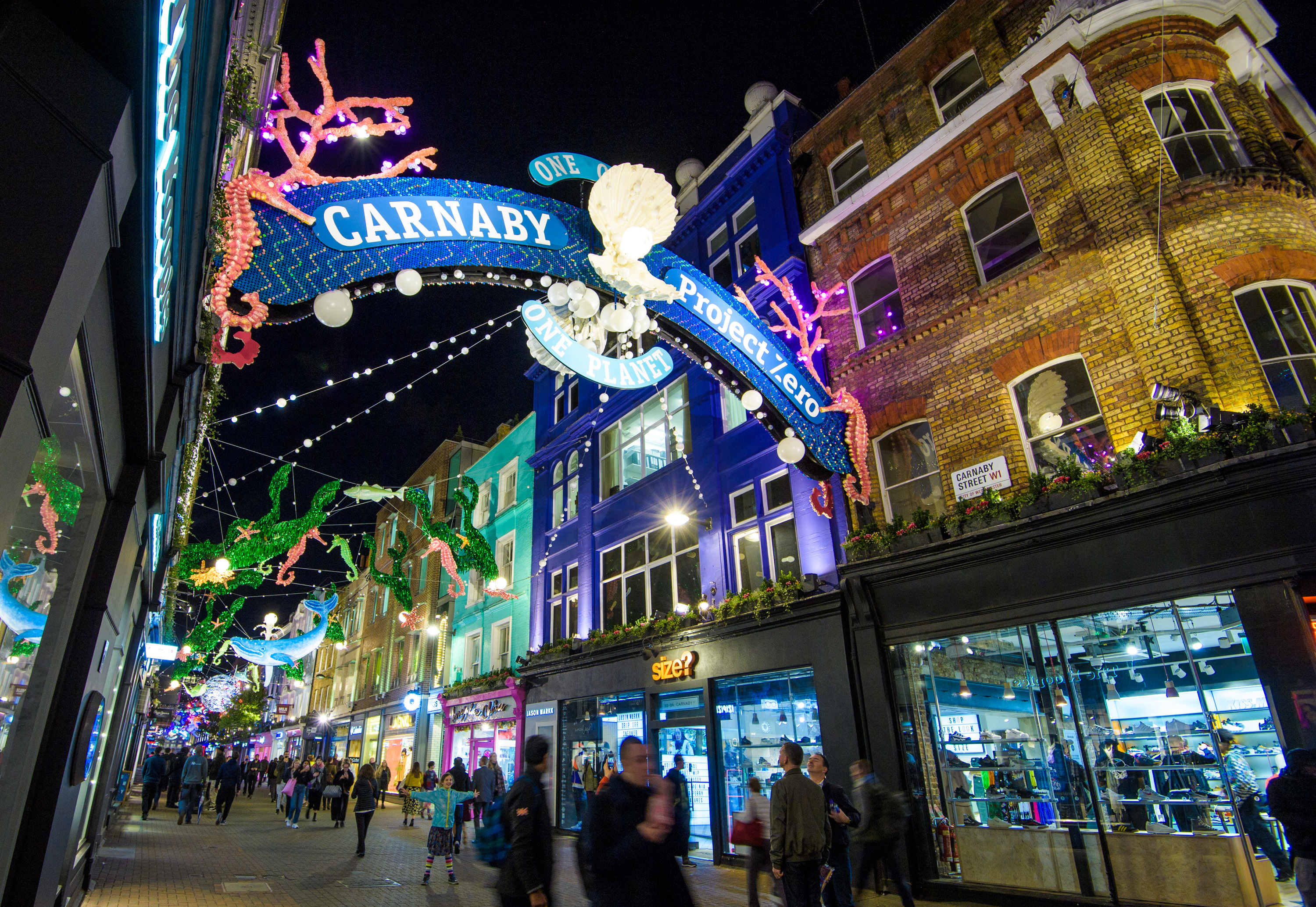 People Walking Under Lightbulb Lights In Carnaby Street