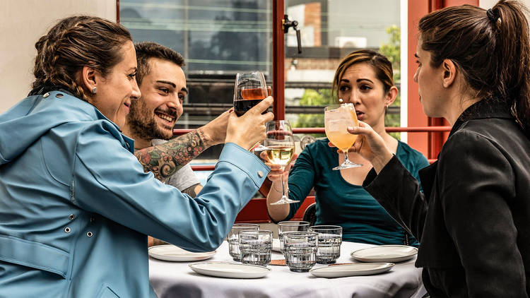 Group of people cheersing at Tetto di Carolina