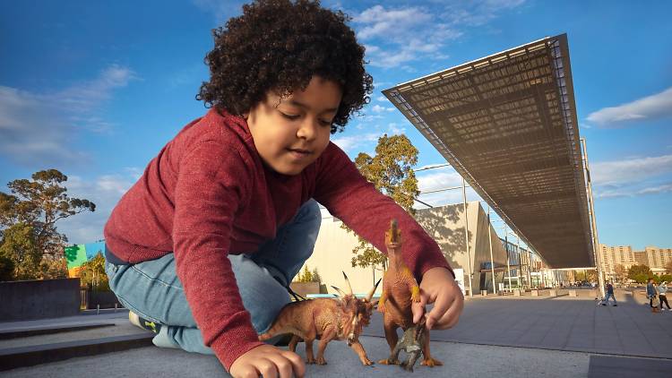 Mini Mega Model Museum child playing with dinosaurs