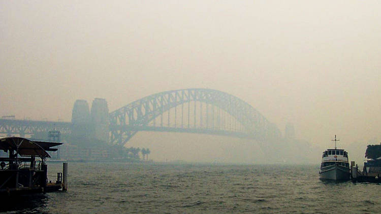 Boat on Sydney Harbour covered in smoke