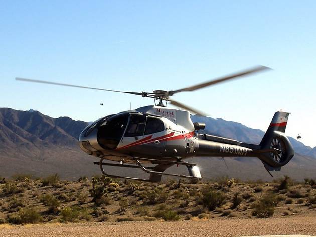 Maverick Helicopter A helicopter lifting off in the desert