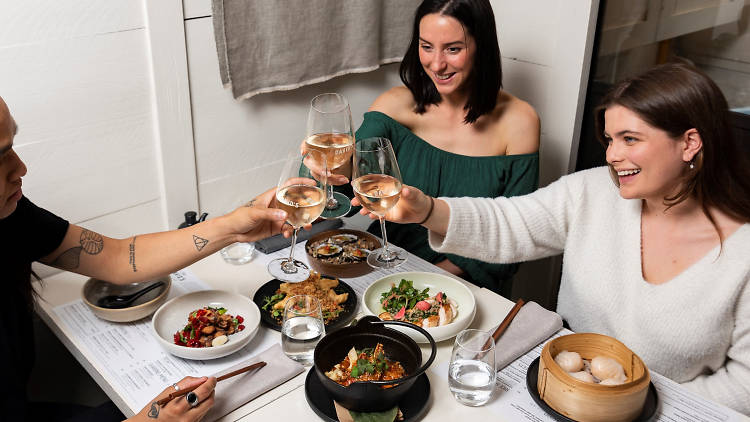 People cheersing around a table