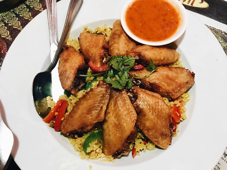 Chicken wings with turmeric rice at Jitlada