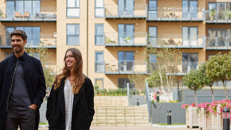 Two people outside an apartment building