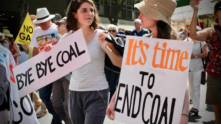 Protesters with signs at Sydney Climate Protest