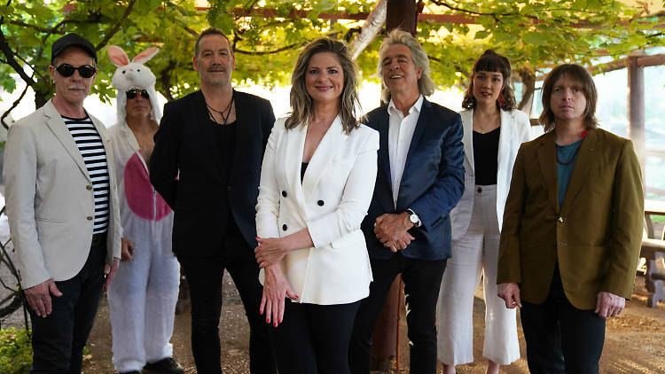 Julia Zemiro, Dugald McAndrew, Brian Nankervis and more people standing underneath a grape vine trellis