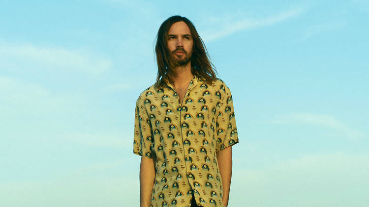 Tame Impala frontman Kevin Parker set against a blue sky