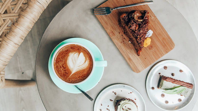 Coffee, cake and a slice on a table at PeanutButterLove