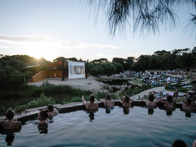 Peninsula Hot Springs Bathe In Cinema 2020 People watch a film from a hot spring