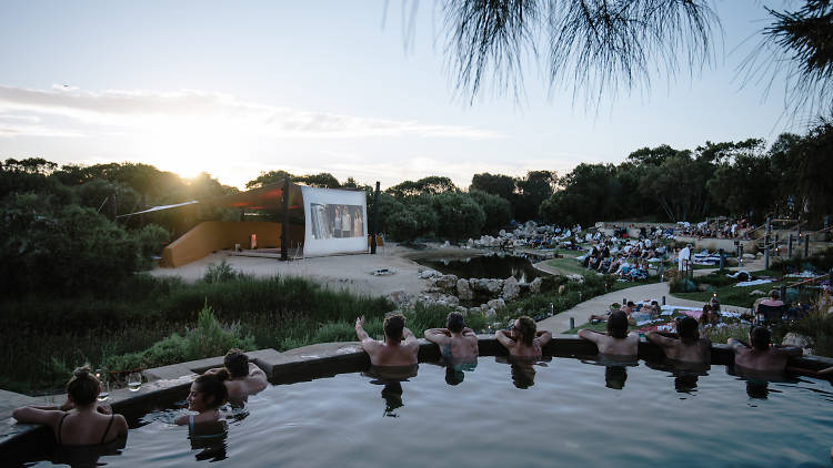 People watch a film from a hot spring