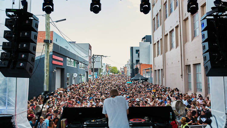 DJ playing in a street filled with people