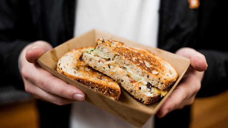 Man holds toasted sandwich