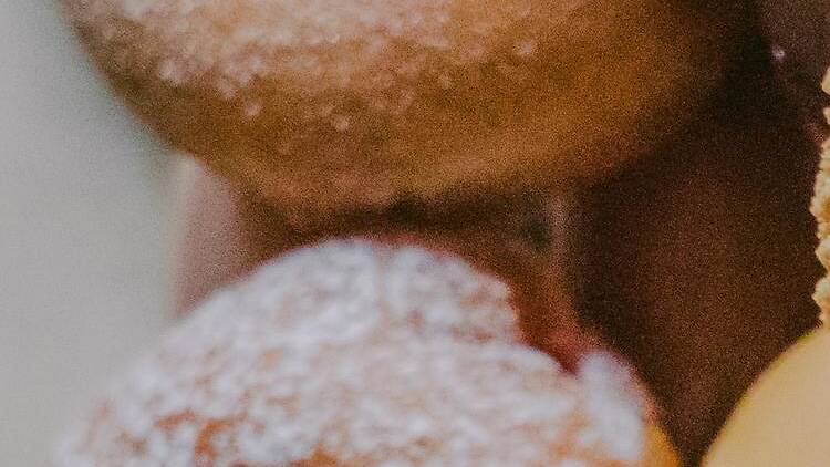 An artfully arranged pile of various flavors of donuts.