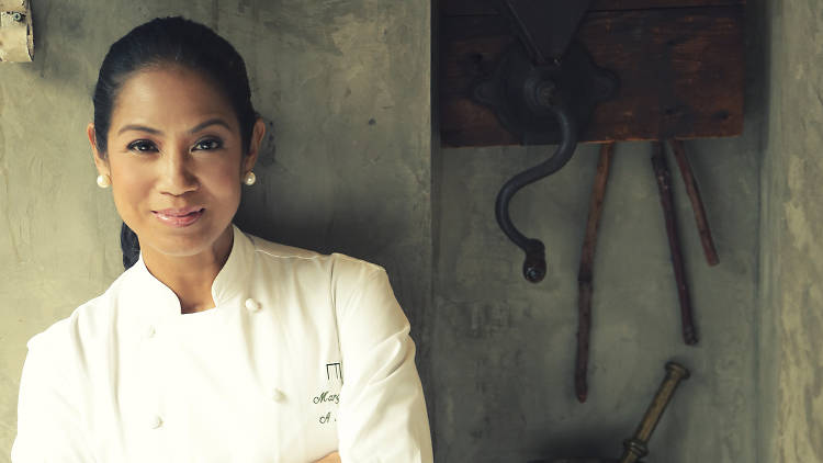 A portrait of chef Margarita Fores leaning against a wall